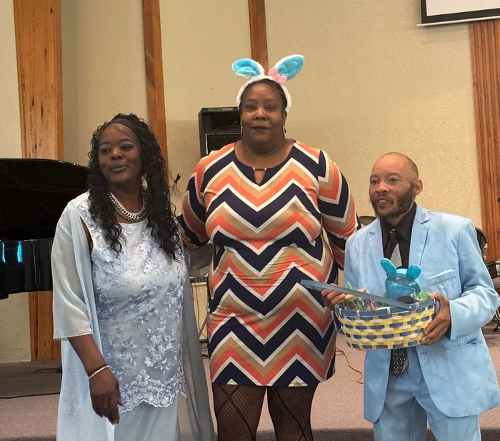 Three adults gathered in the sanctuary at Gideon’s Lighthouse on Easter Sunday.